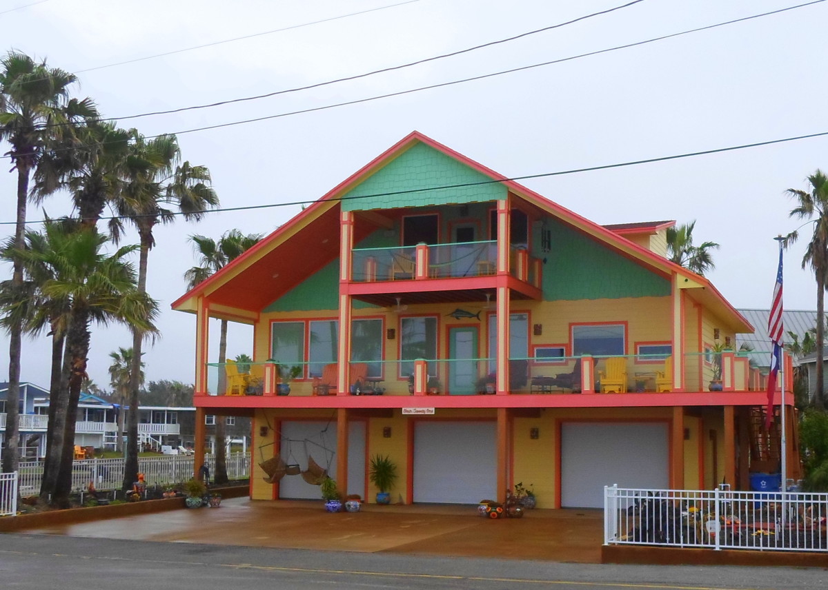 A three story yellow, peach and teal house.