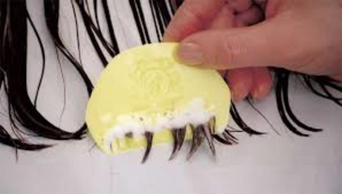 Wet combing with conditioner for diagnosis and treatment. Head lice can be seen in foam.