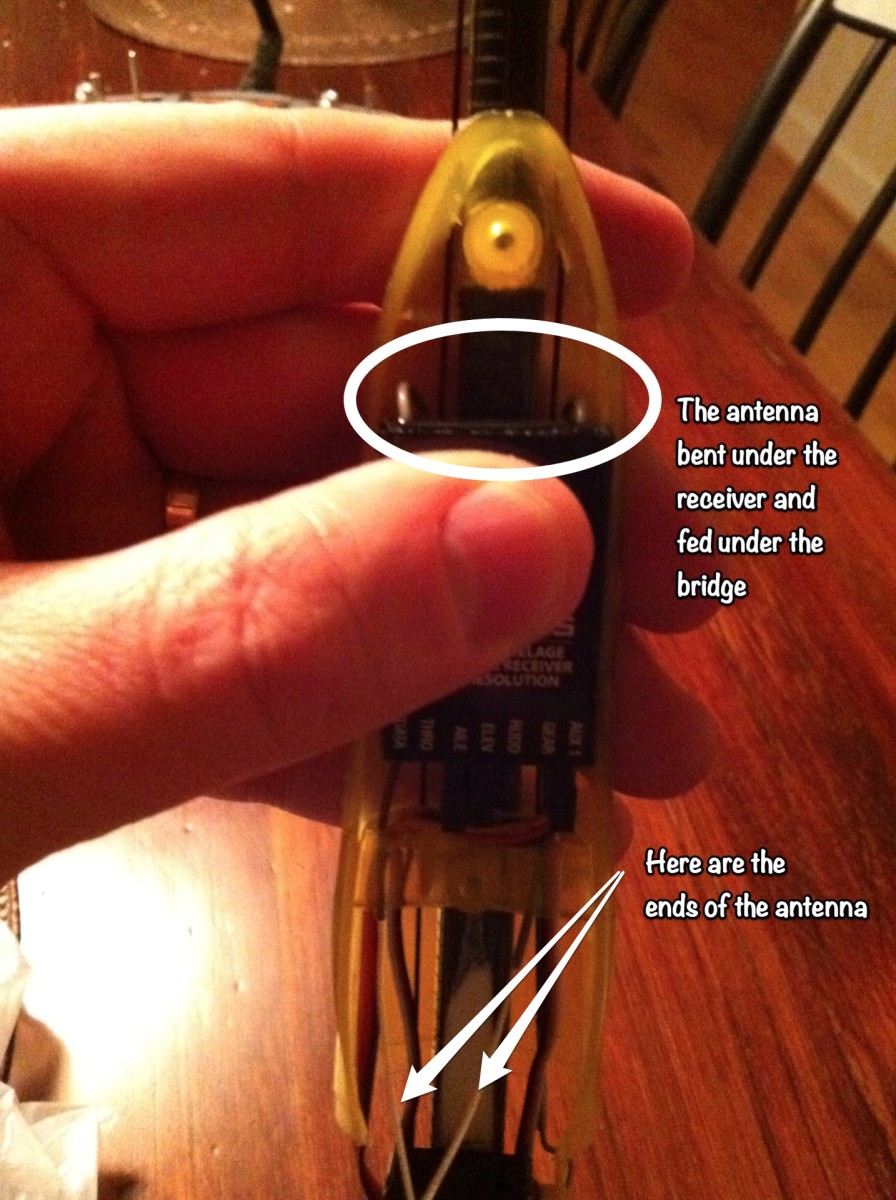 One option is to route the antenna under the receiver and through the plastic bridge.