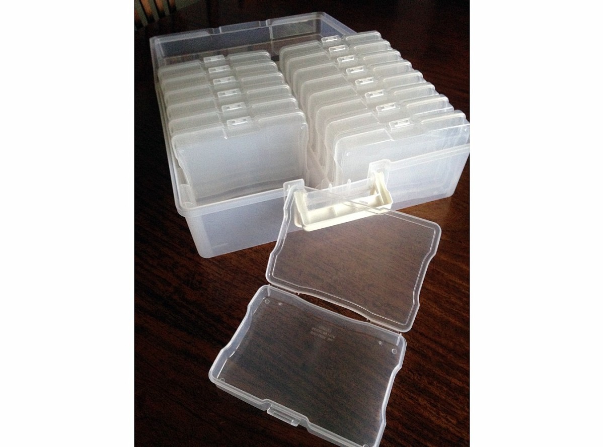 Plastic storage boxes for postcards or photos, contained in a larger box/carrying case.