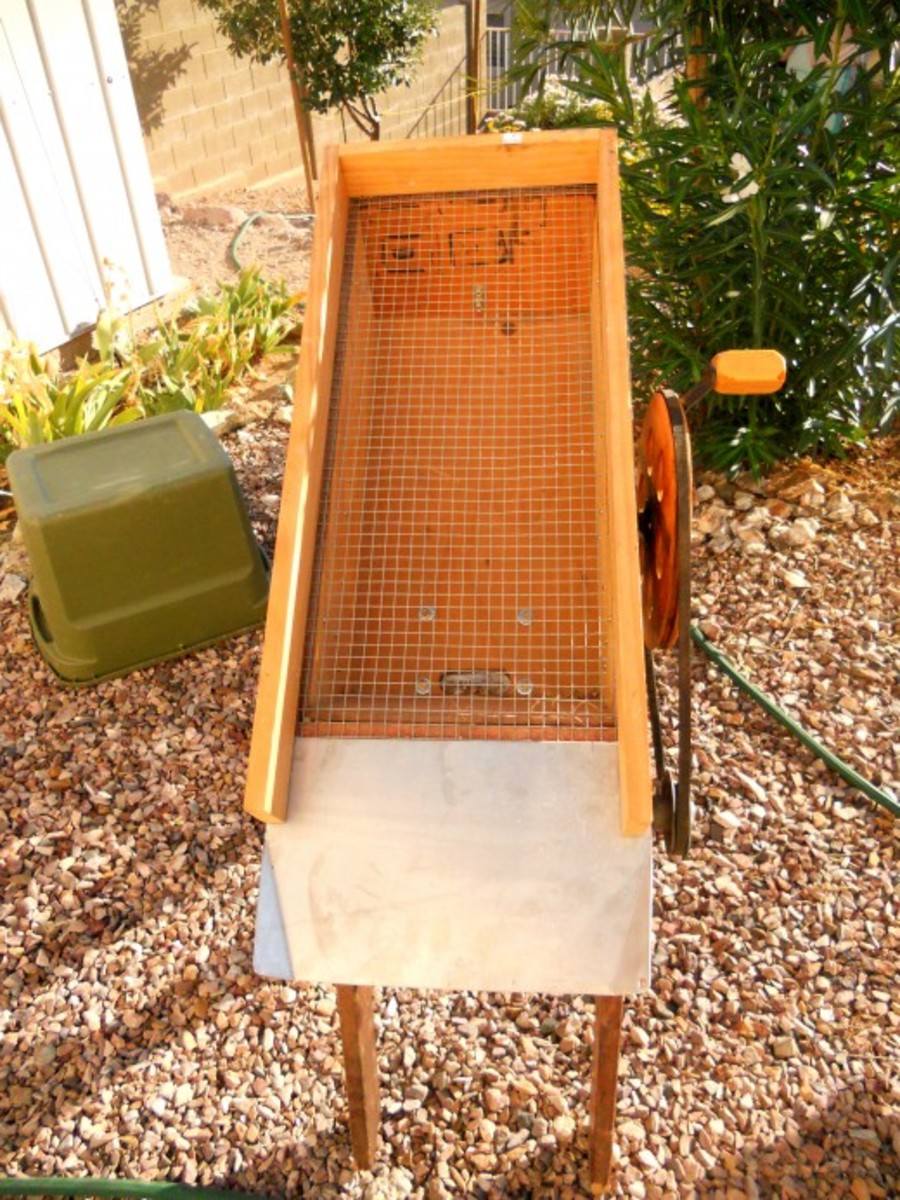 This is a top view of the hopper. Notice the screening which classifies the material. Also, notice the chute at the bottom where the rocks are guided off.