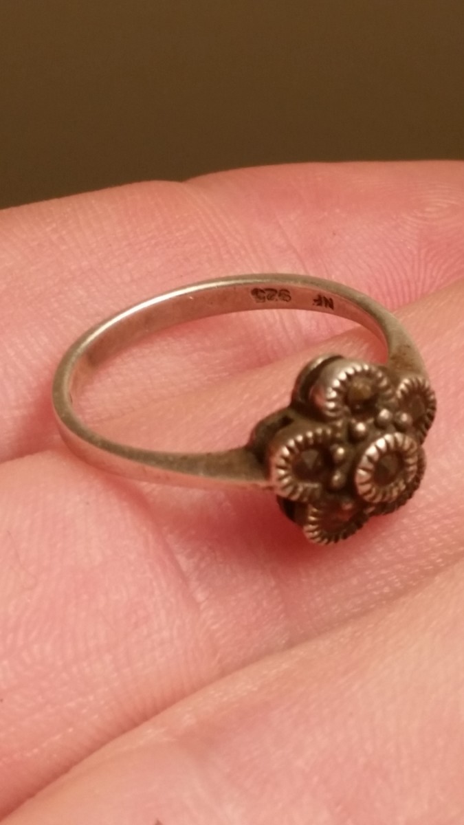 A silver ring I found while metal detecting sidewalk grass.