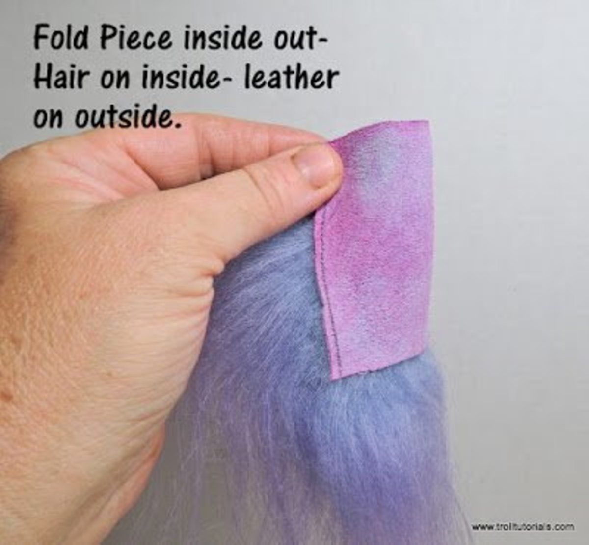 1. Fold the hair as shown above with the hair on the inside and the leather on the outside. 