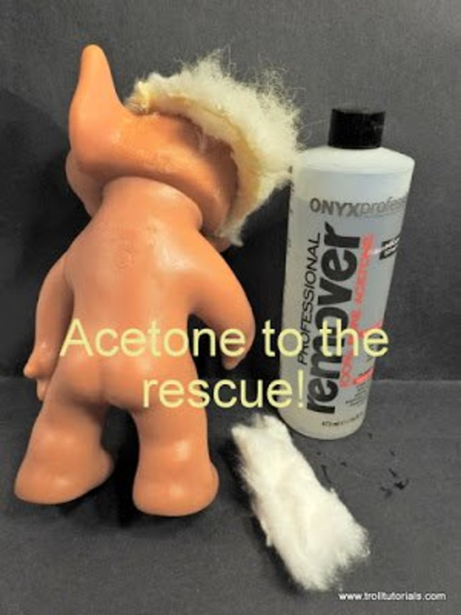 Cotton balls and acetone can be used to soak the base of the hair where it is glued to the doll's head.