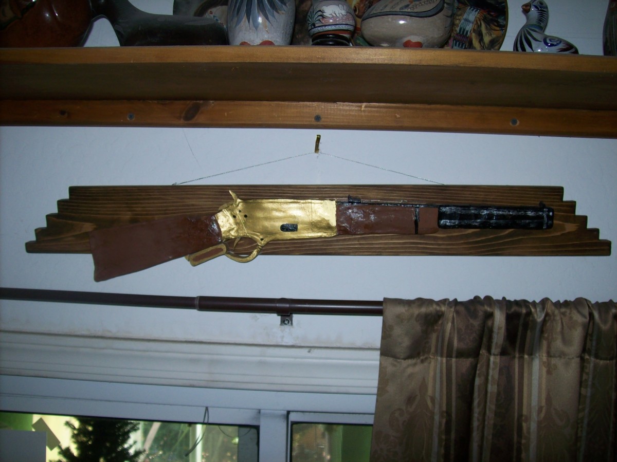 Notice the shiny brass receiver. Hence, the appellation "Yellow Boy." The short rifle is mounted on a separate piece of wood.