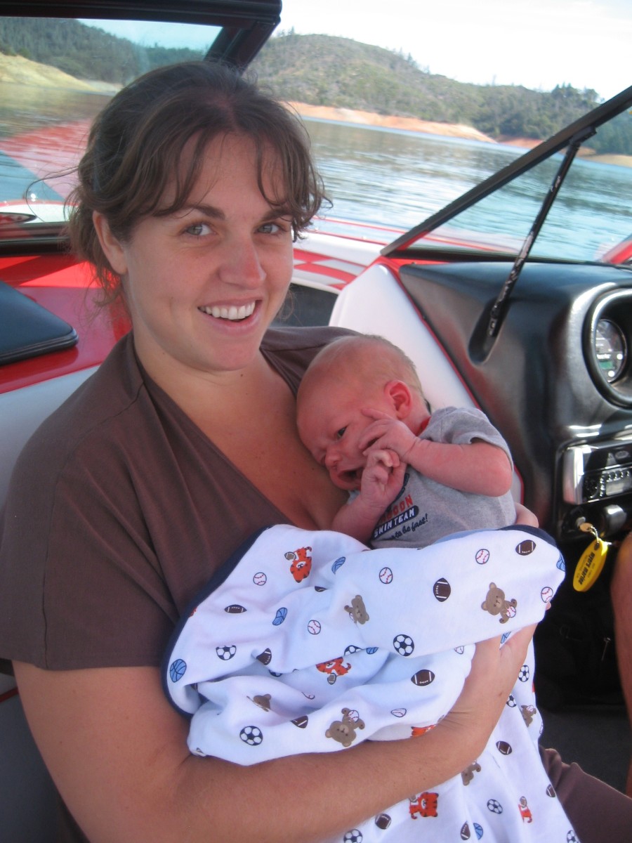 Pure happiness, new mommy on the lake in the sunshine.