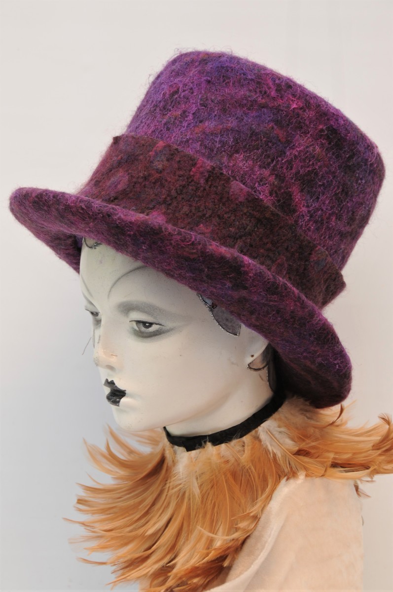 A double brimmed wet-felted top hat made using a vintage Moët and Chandon top hat- shaped ice bucket.