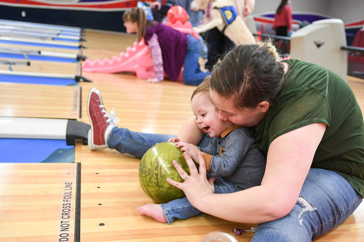 Alyssa Carvajal bowls with her son, Easton, Jan. 30, 2019, at the bowling event held by Exceptional Family Member Program-Family Support at Hill Air Force Base, Utah.