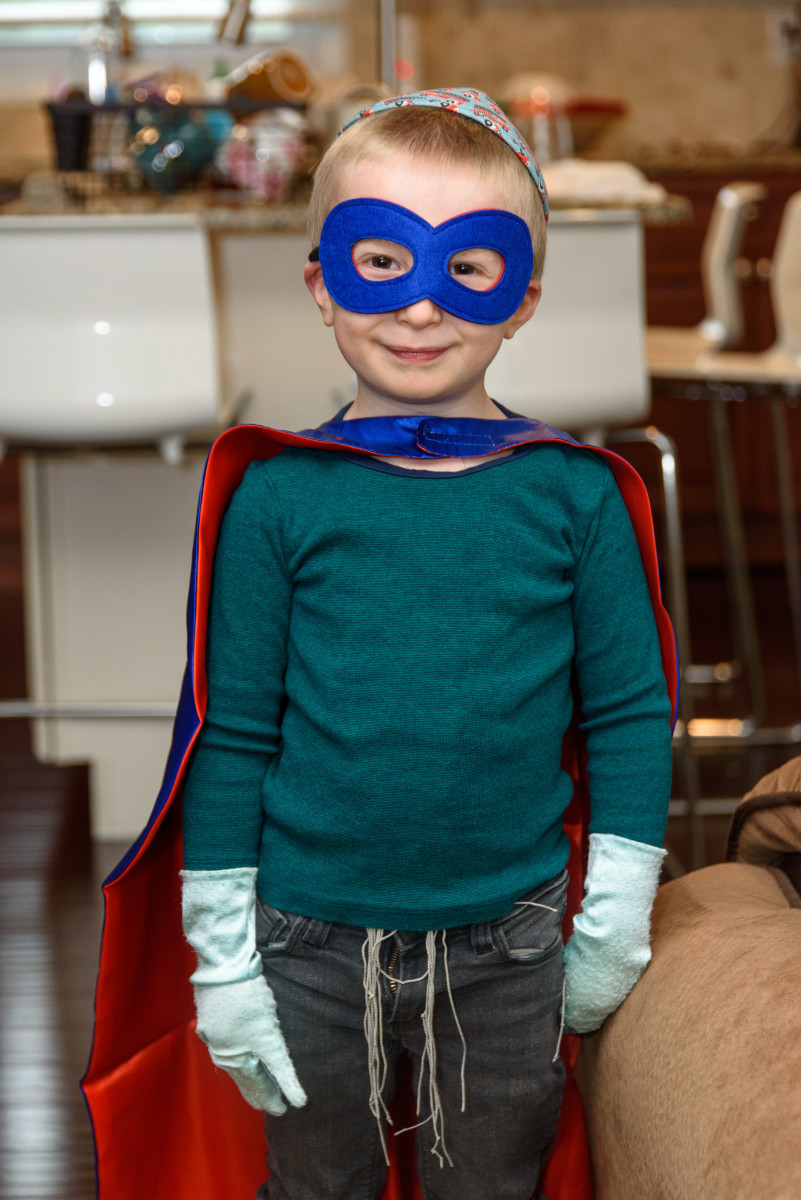 My 4 year old son doing a photoshoot in his superhero costume for his book.