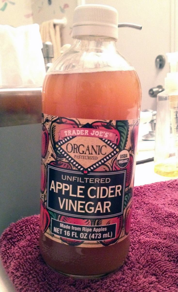 A bottle of apple cider vinegar, which is a simple but effective ingredient in many homemade skincare products.