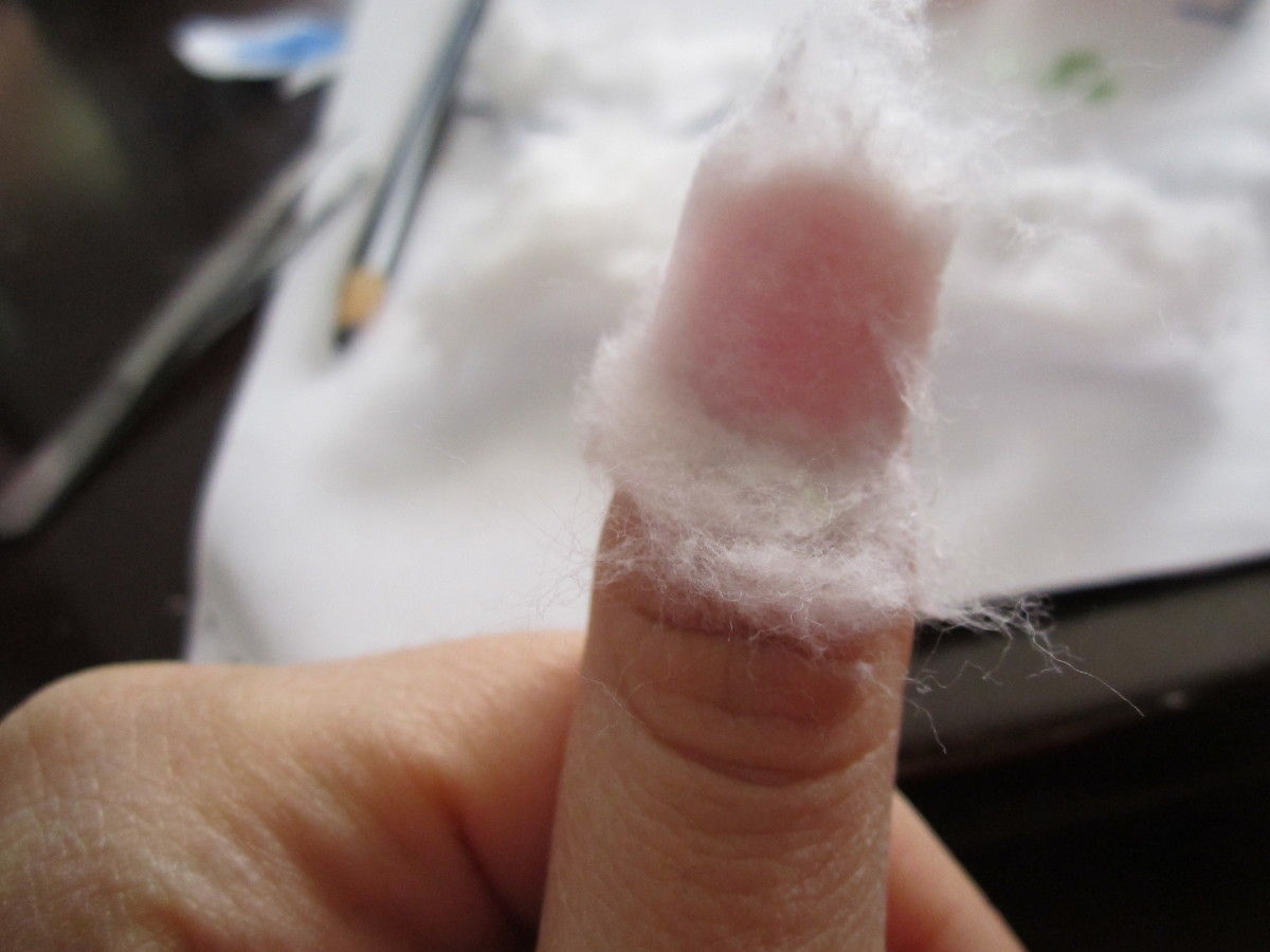 Dip cotton ball pieces in remover and cover nails with it.