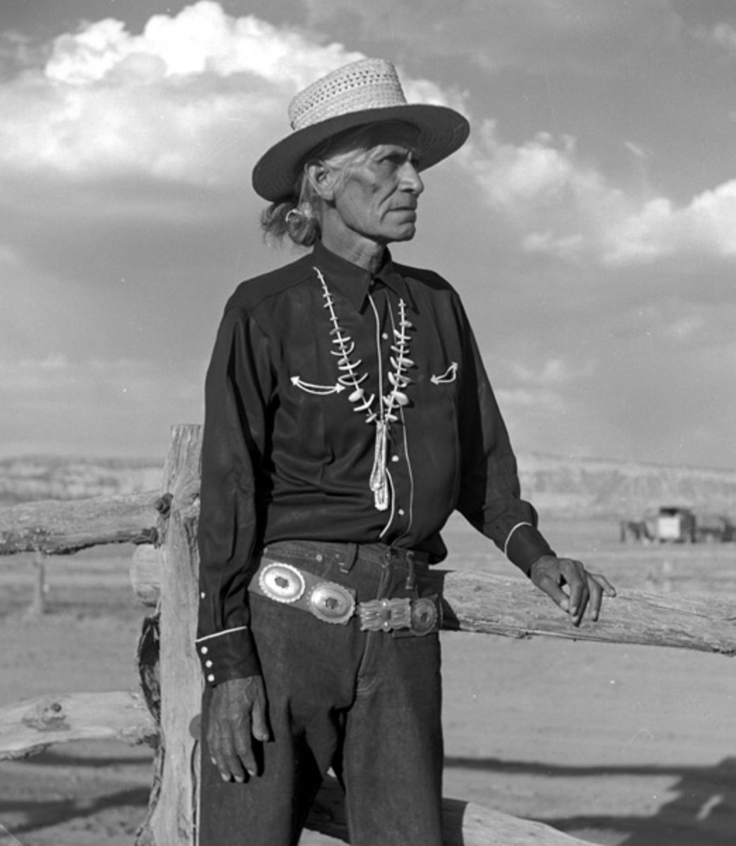 photo by Don Blair of an elderly man in traditional Navajo dress wearing a concho belt turquoise necklace and straw hat
