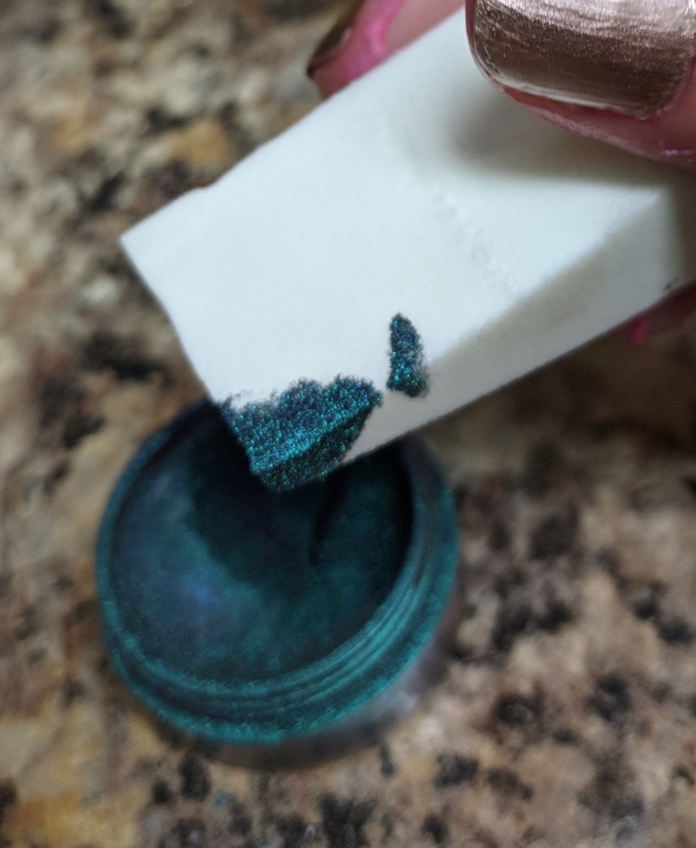Dab the sponge into the nail powder very lightly.