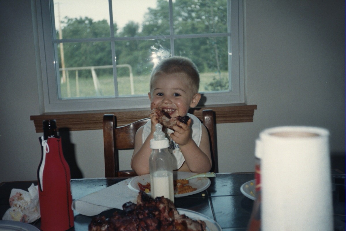 Lil' Britches as a toddler enjoying some babyback ribs