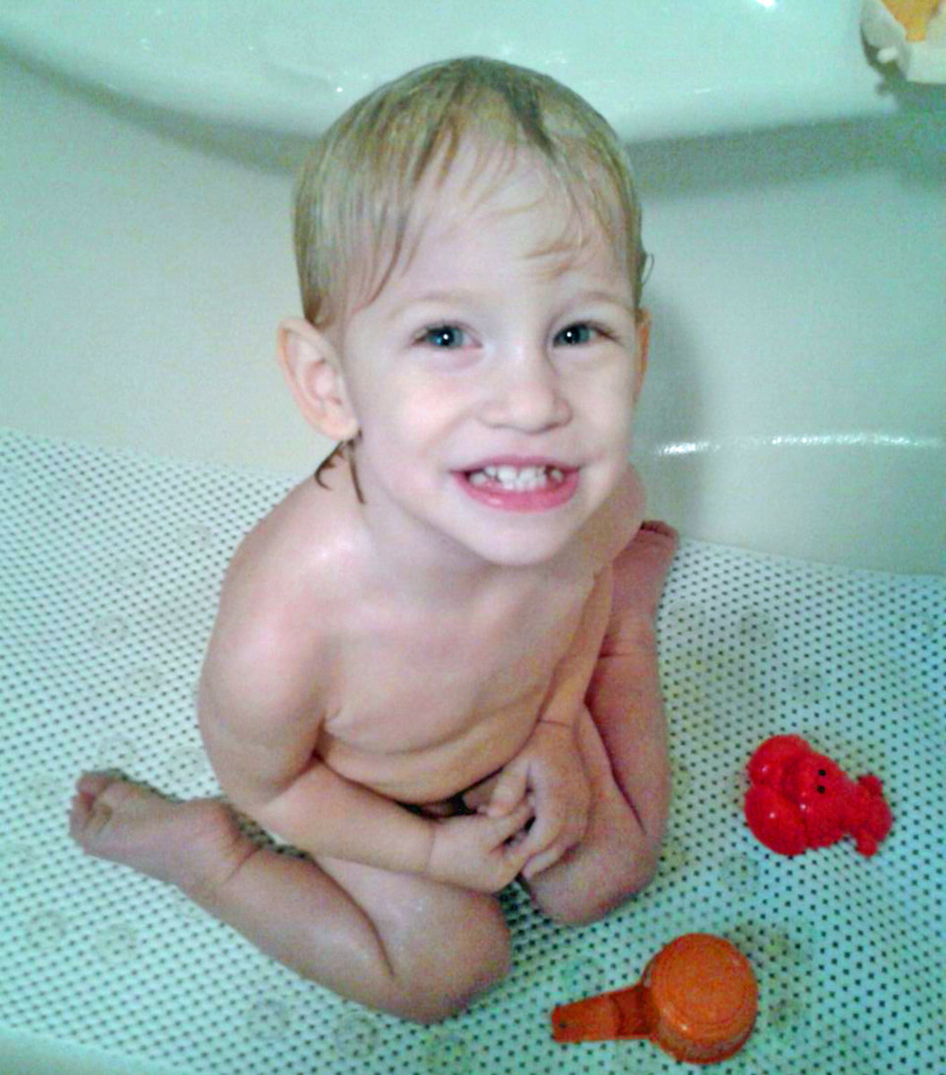 My toddler after his rash-eliminating bathtub soak. See, much happier! (Ignore the forced smile... I promise, he's happy.)