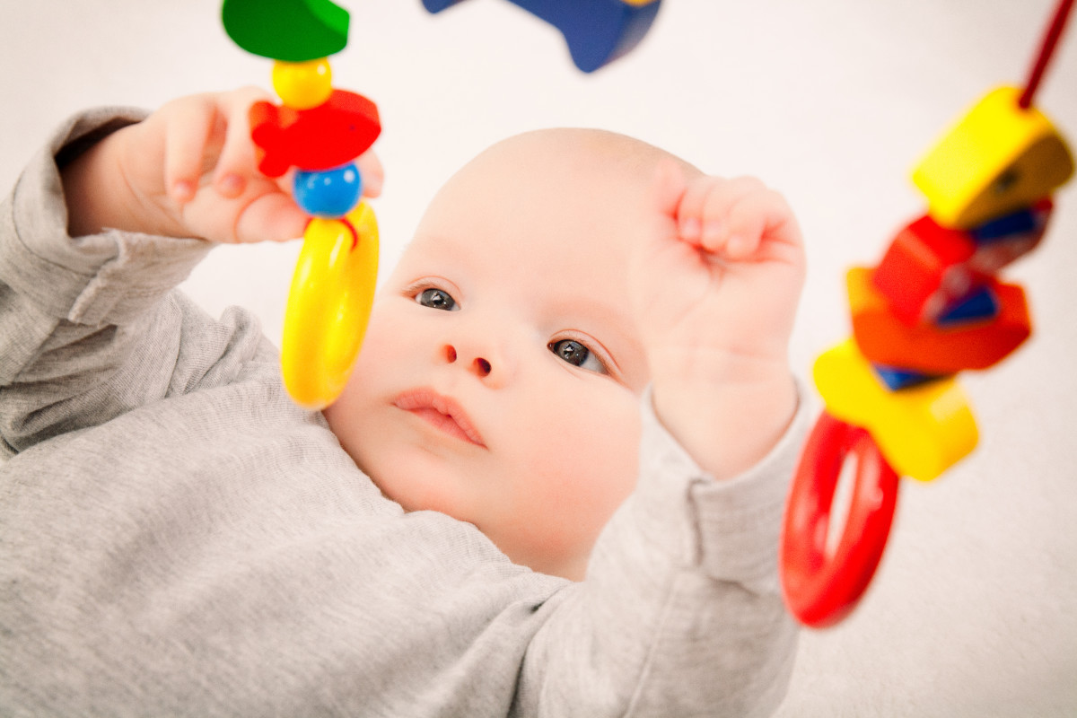 Although neutral colored toys may fit your aesthetic better, keep brightly colored toys on hand too - they aid in baby's visual development.