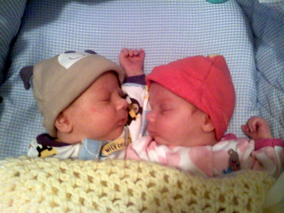 Here is a pair of fraternal newborn twins sleeping.