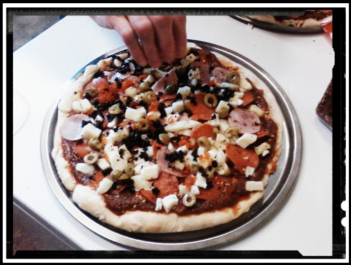 Putting toppings on the pizzas can be the best part, if you have a variety of toppings and a few hungry - but helpful - people.