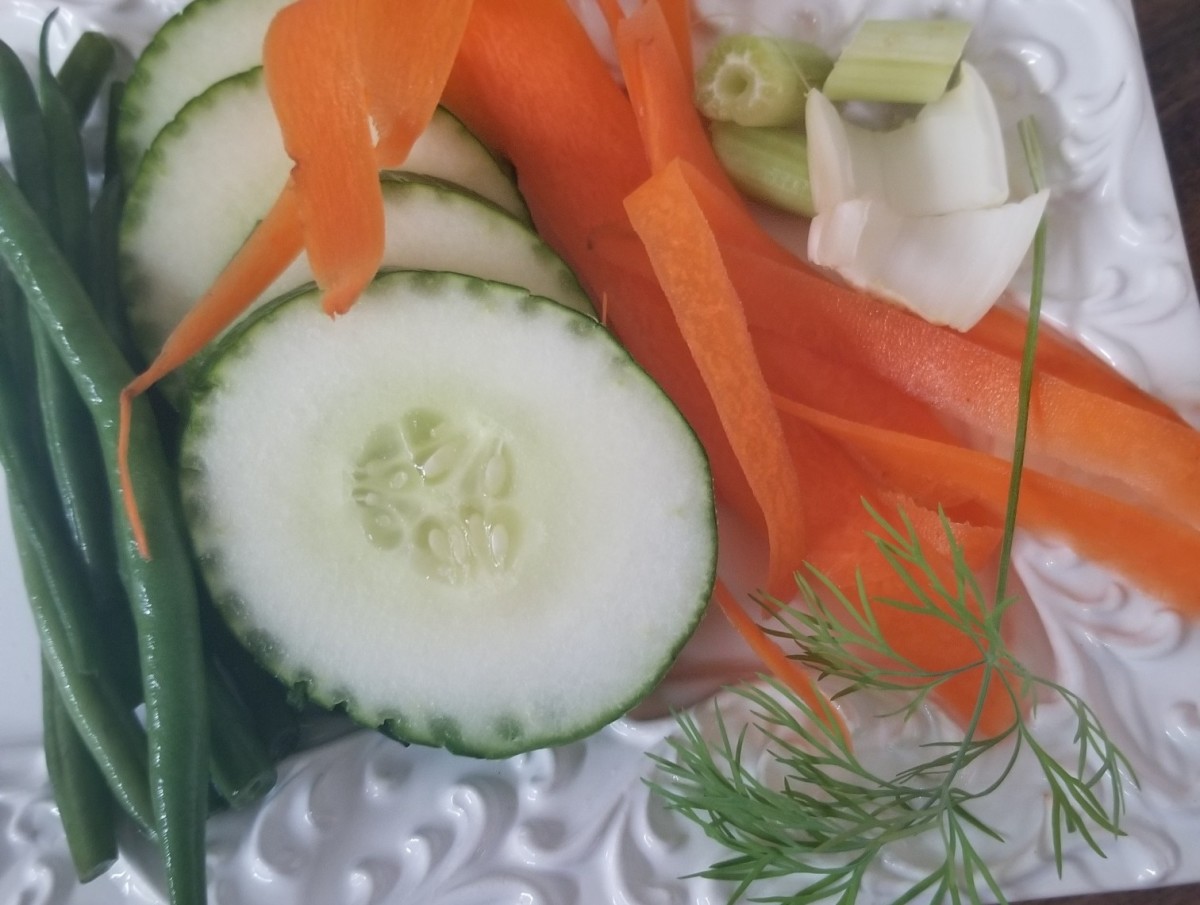Presentation and color can make vegetables more interesting. This plate showcases vegetables in a variety of shapes and textures that may catch a child's eye.