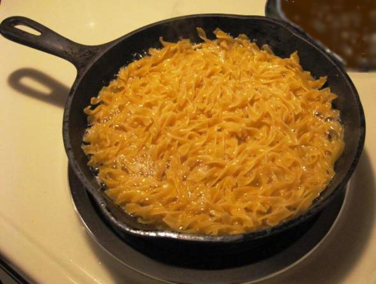 Noodle mixture poured into pre-heated oil in frying pan