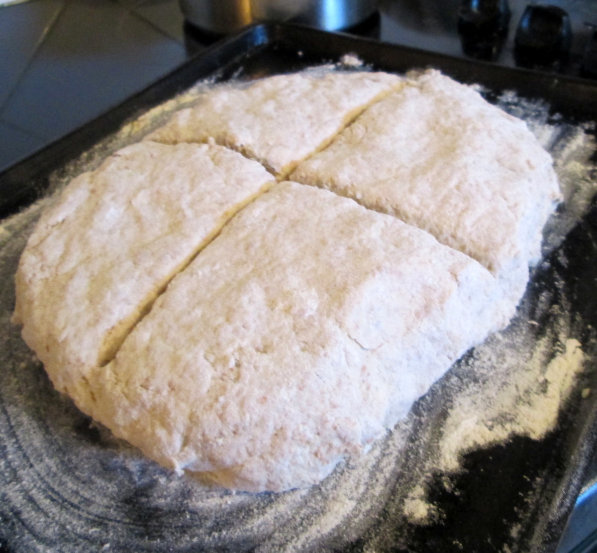 Learn how to make the cross for Irish soda bread: Using a large knife, cut down and across to make a deep cut in the dough of the soda bread. 