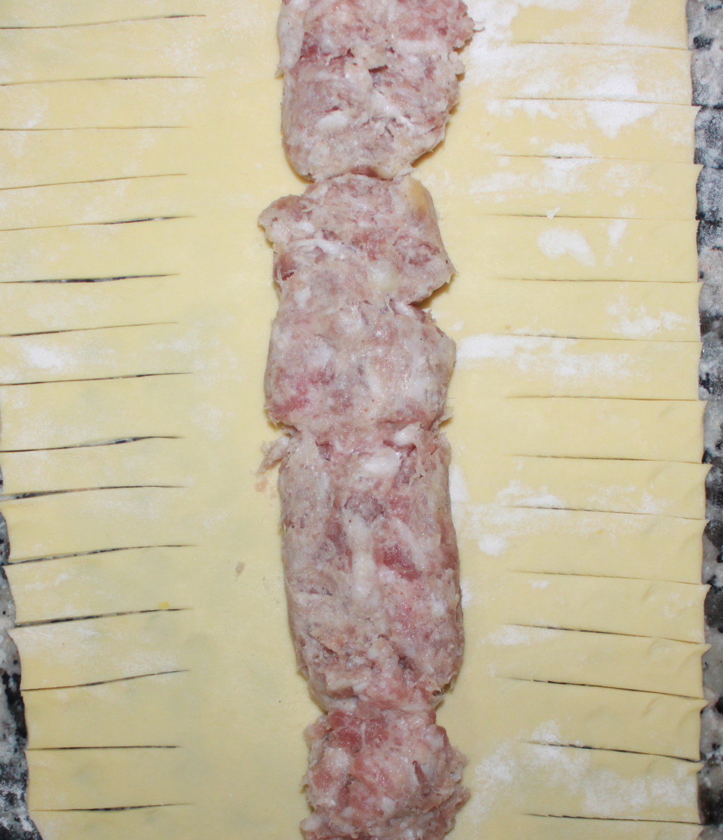 Fig 2) Cut the pastry from the sausage meat to the pastry edge on both sides 