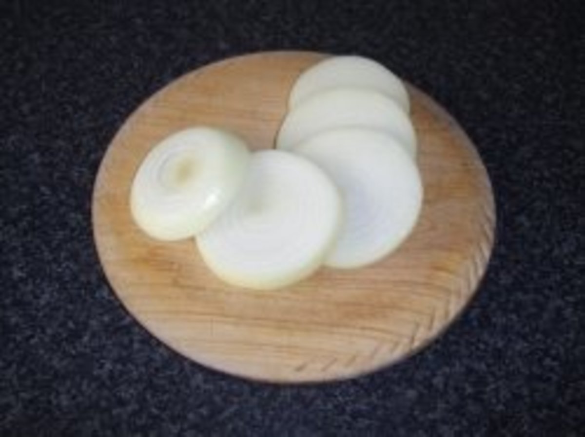 The onion is first peeled and sliced.