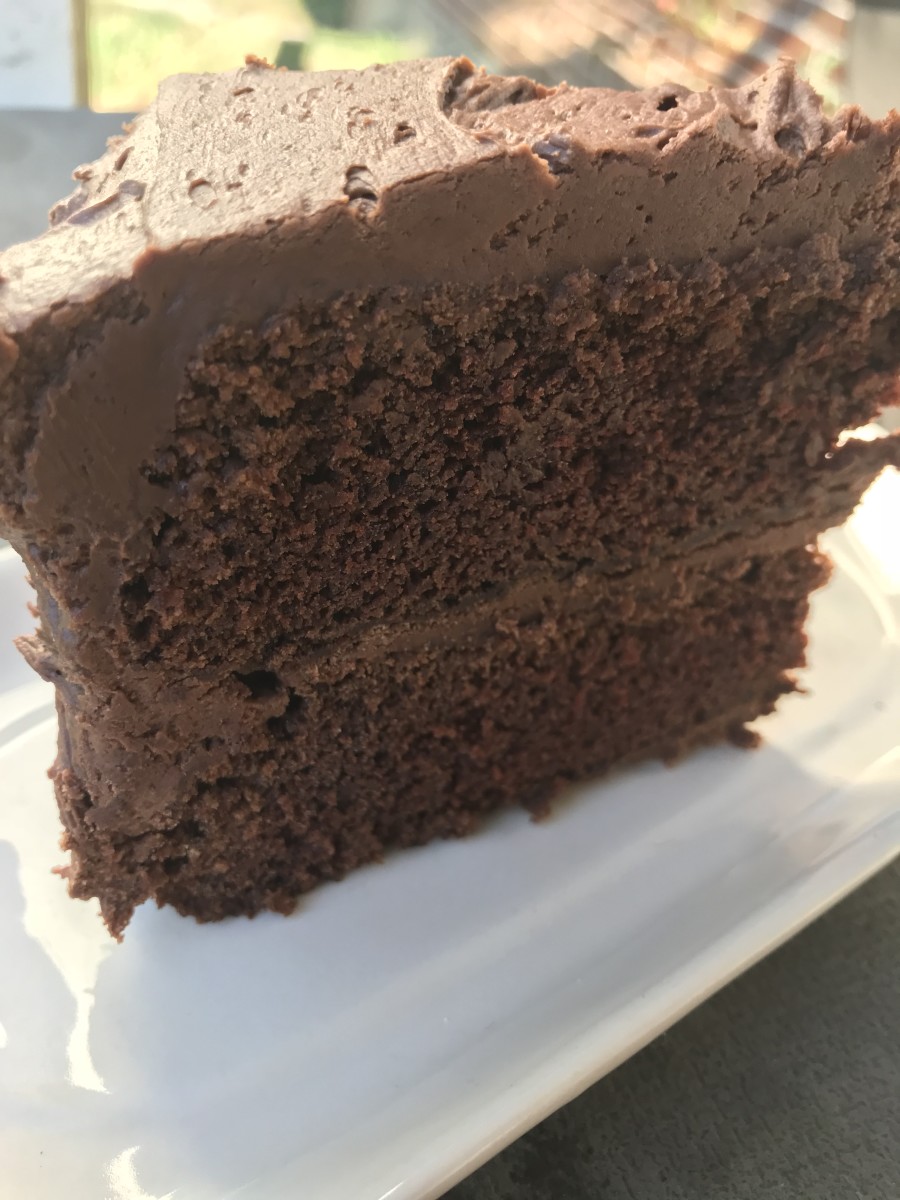 Chocolate fudge frosting looking irresistible on a chocolate fudge cake. 
