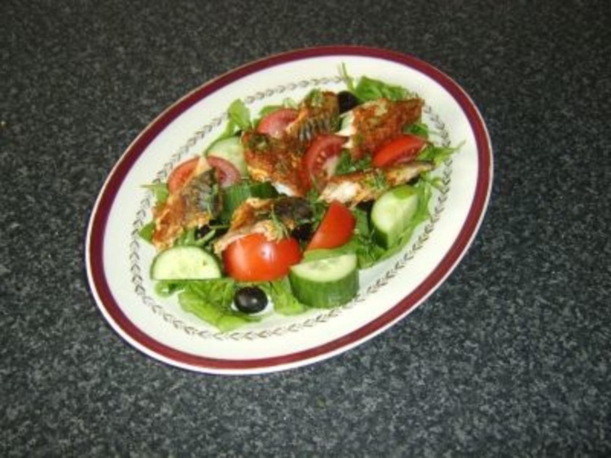 Mackerel is coated in red pesto sauce before being baked and served on a simple salad bed