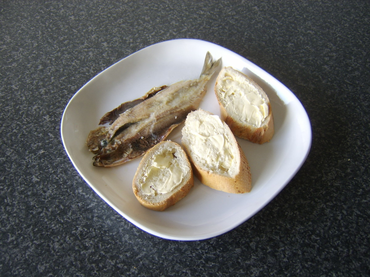 SImply grilled split herring is served with bread and butter.