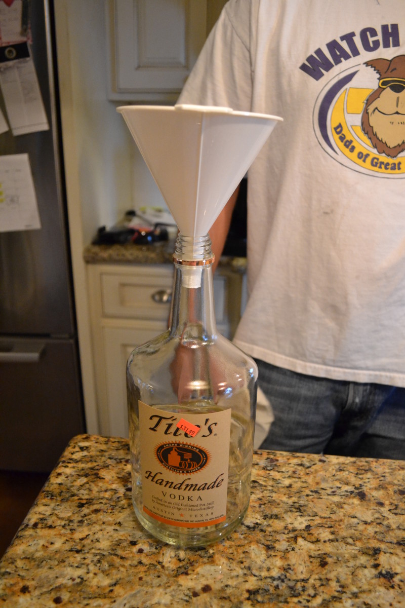 Step 5: Place a funnel in the original vodka bottle.