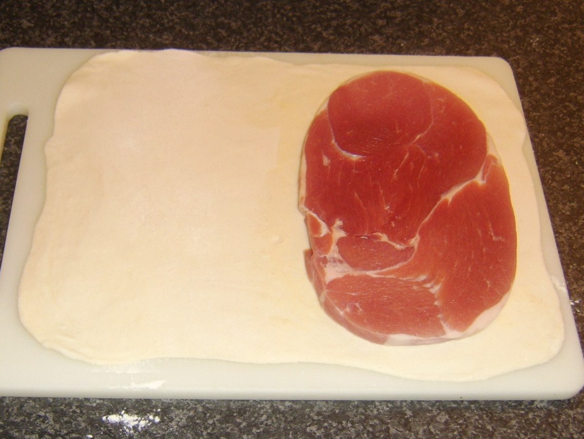 Gammon steak is laid on one half of the rolled pastry