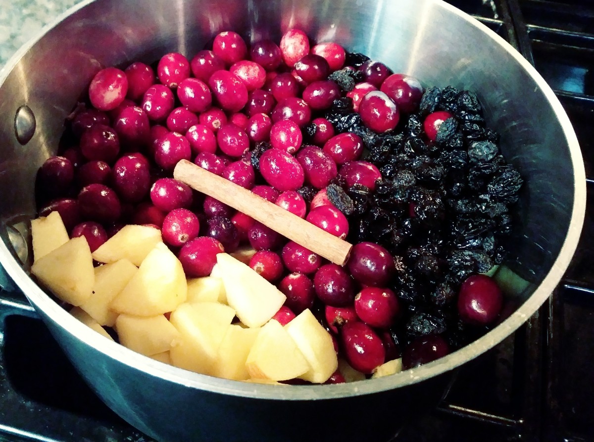 The ingredients for Cranberry-Apple Sauce are placed in a pot.