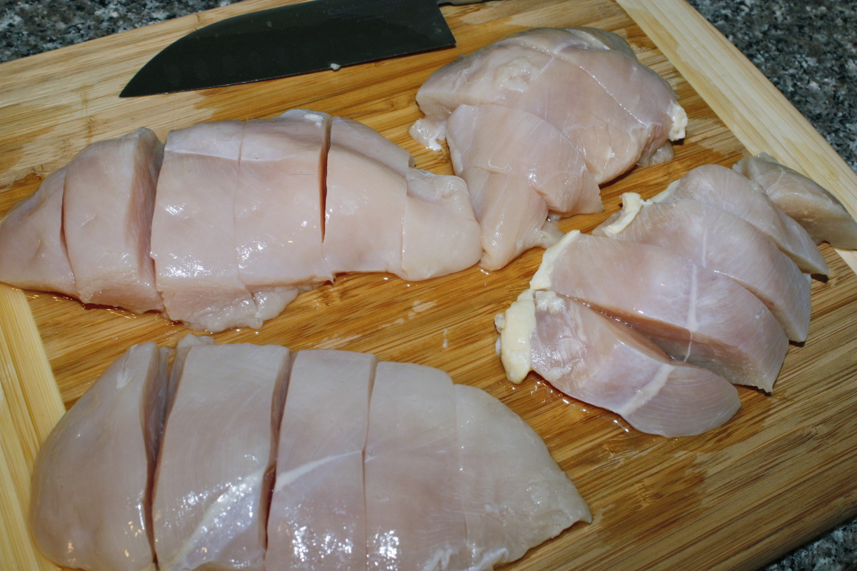 Chicken cut into long strips for the skewers.