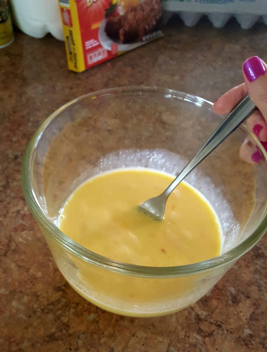 Mix eggs and a little milk together in a bowl for scrambled eggs