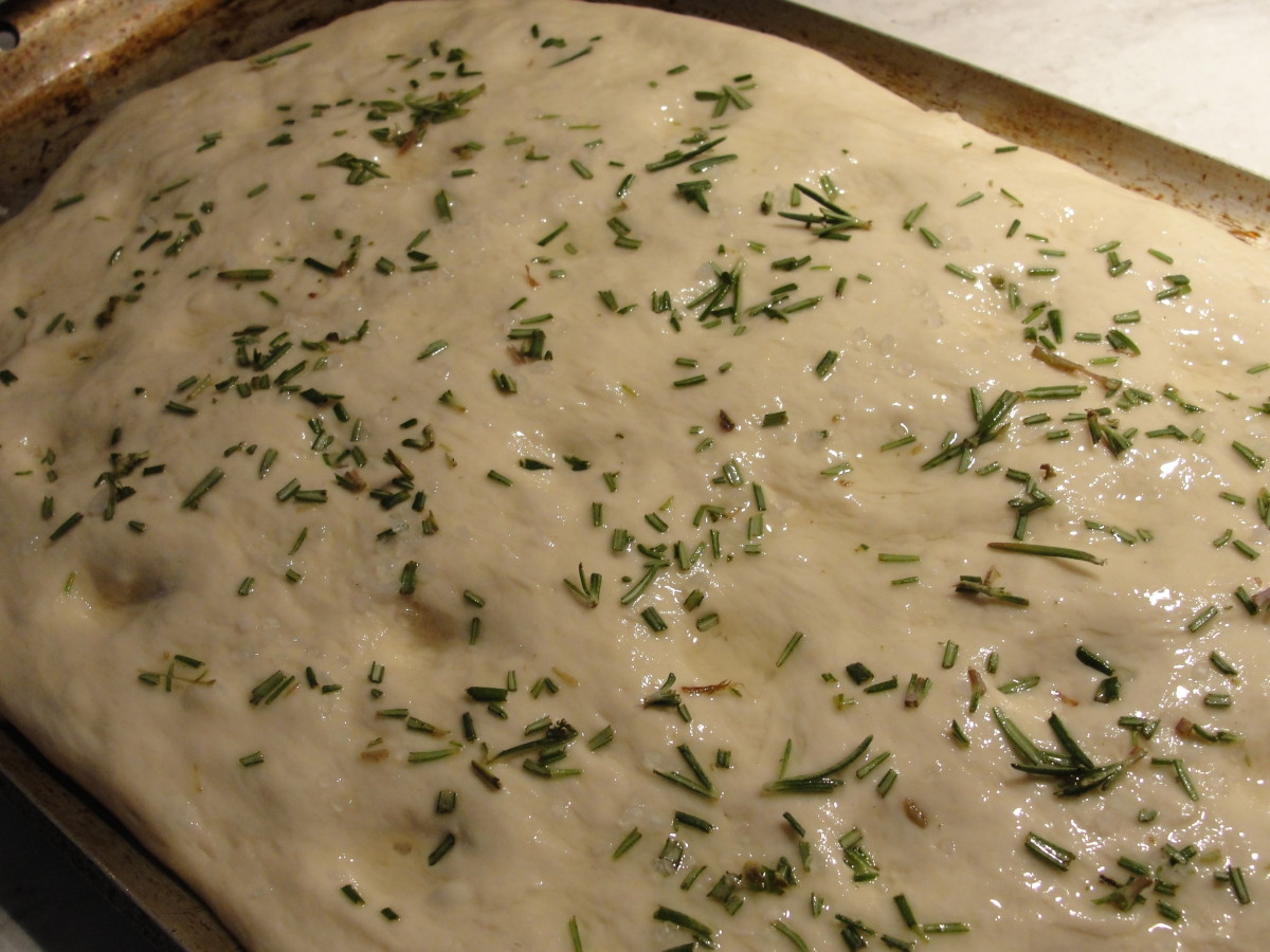 Dough brushed with oil, sprinkled with chopped rosemary and coarse salt, and dimpled. It's ready for the final proofing