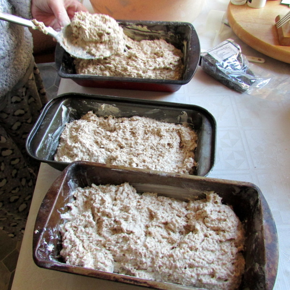Using a large spoon, fill the tins with the bread mixture up to three-quarters full.