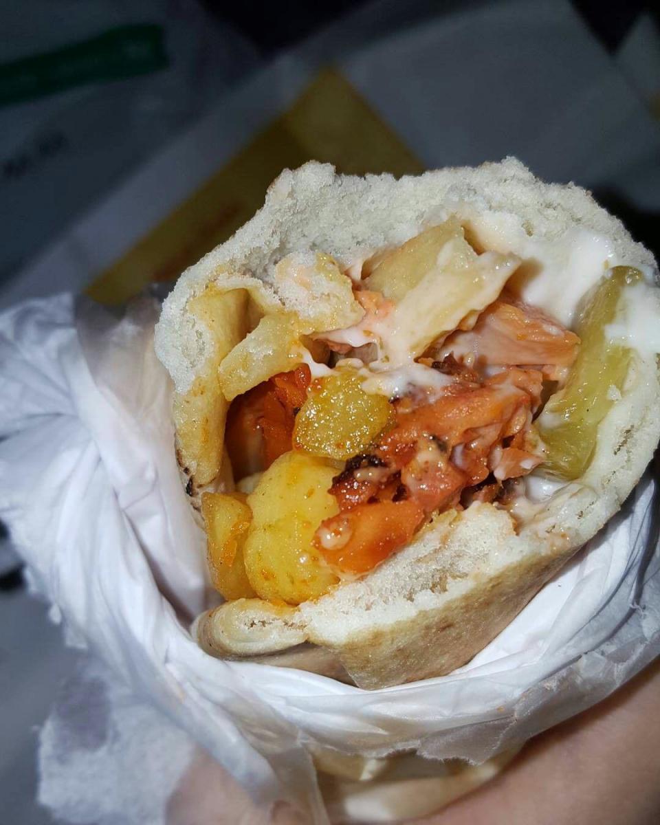 Picture of spicy chicken shawarma with French fries, mayonnaise and turshi.