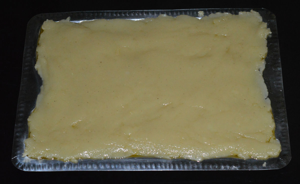 Pour it on the greased tray. Flatten, and extend till the edges. Keep aside for cooling.