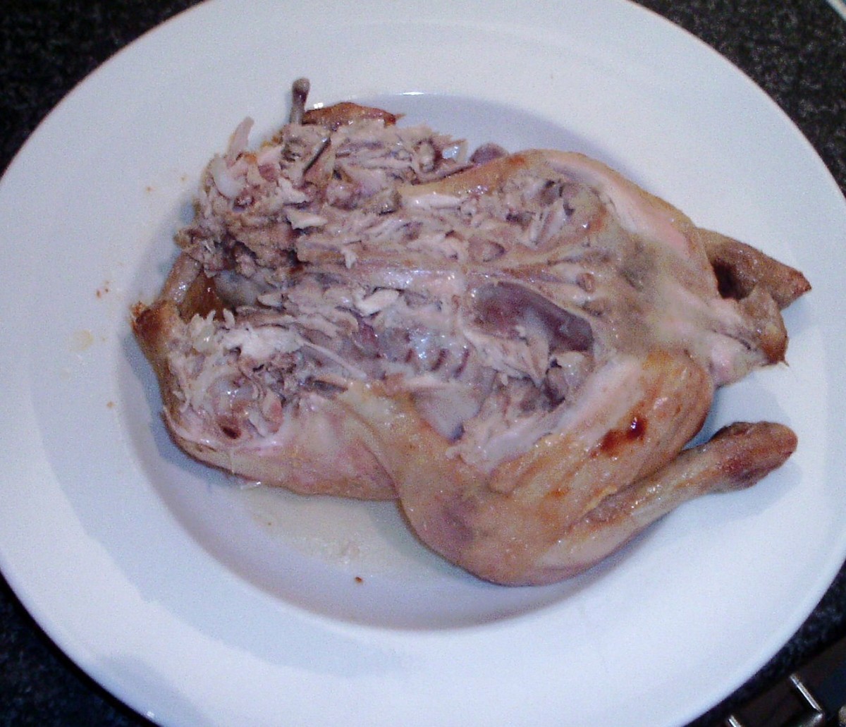 Meat is plucked from the back of the rested roast chicken
