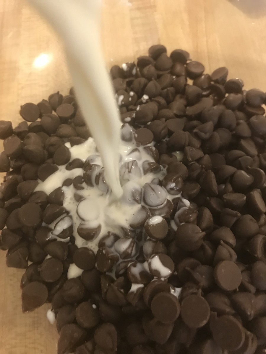 Pour the scalded cream over the dark chocolate in the bowl. Let it sit for a few seconds before you begin to stir.