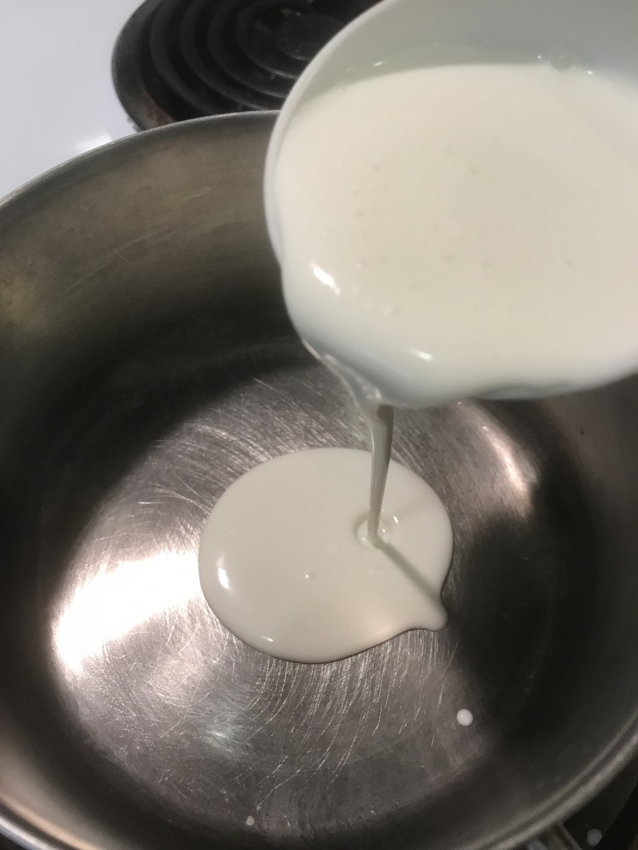 Scalding the cream by bringing it just to a boil but not letting it fully boil. This is a key step. Use a heavy-bottomed saucepan and watch it to just start forming bubbles. Remove from heat immediately.