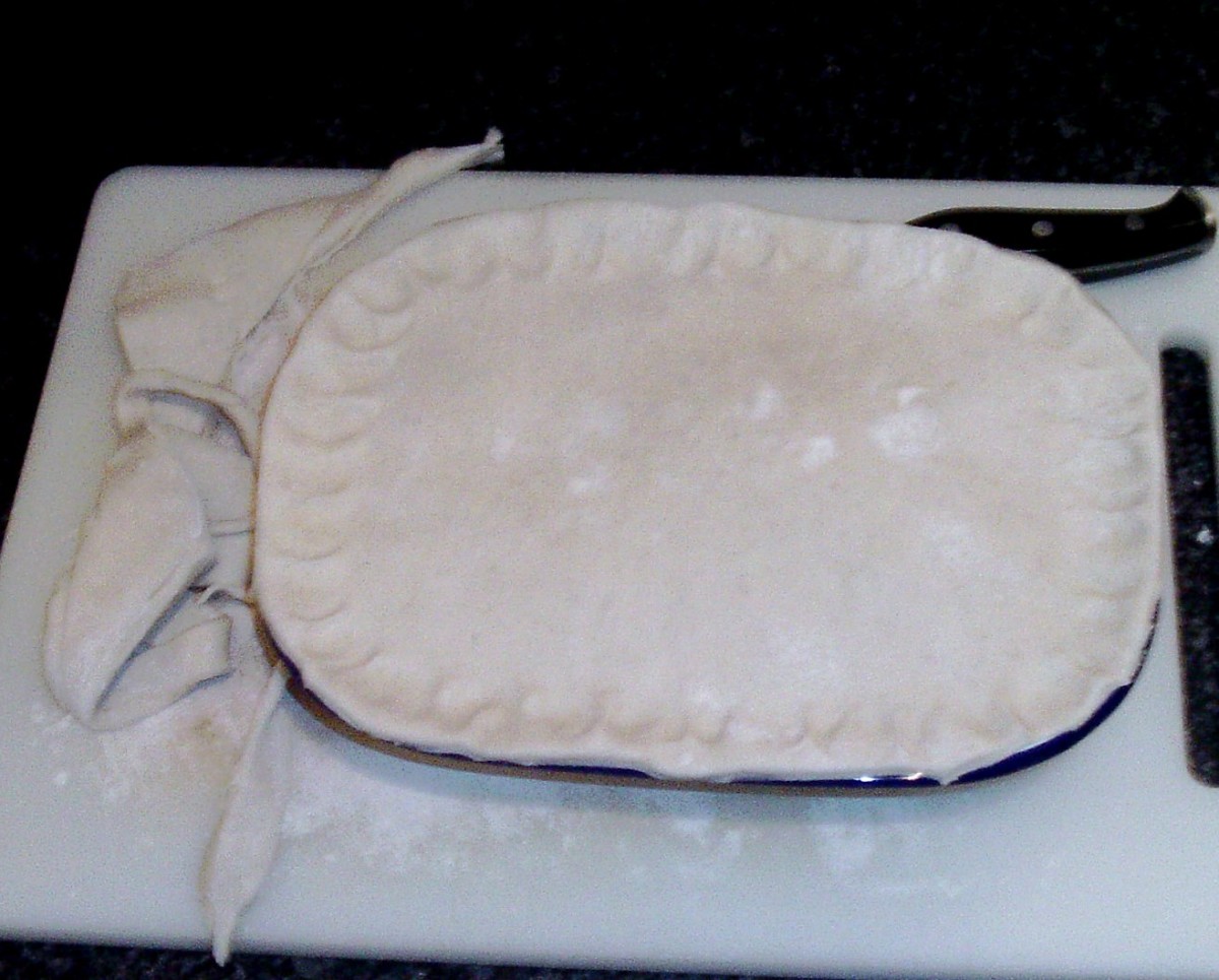 Pastry is trimmed around edges of pie dish.
