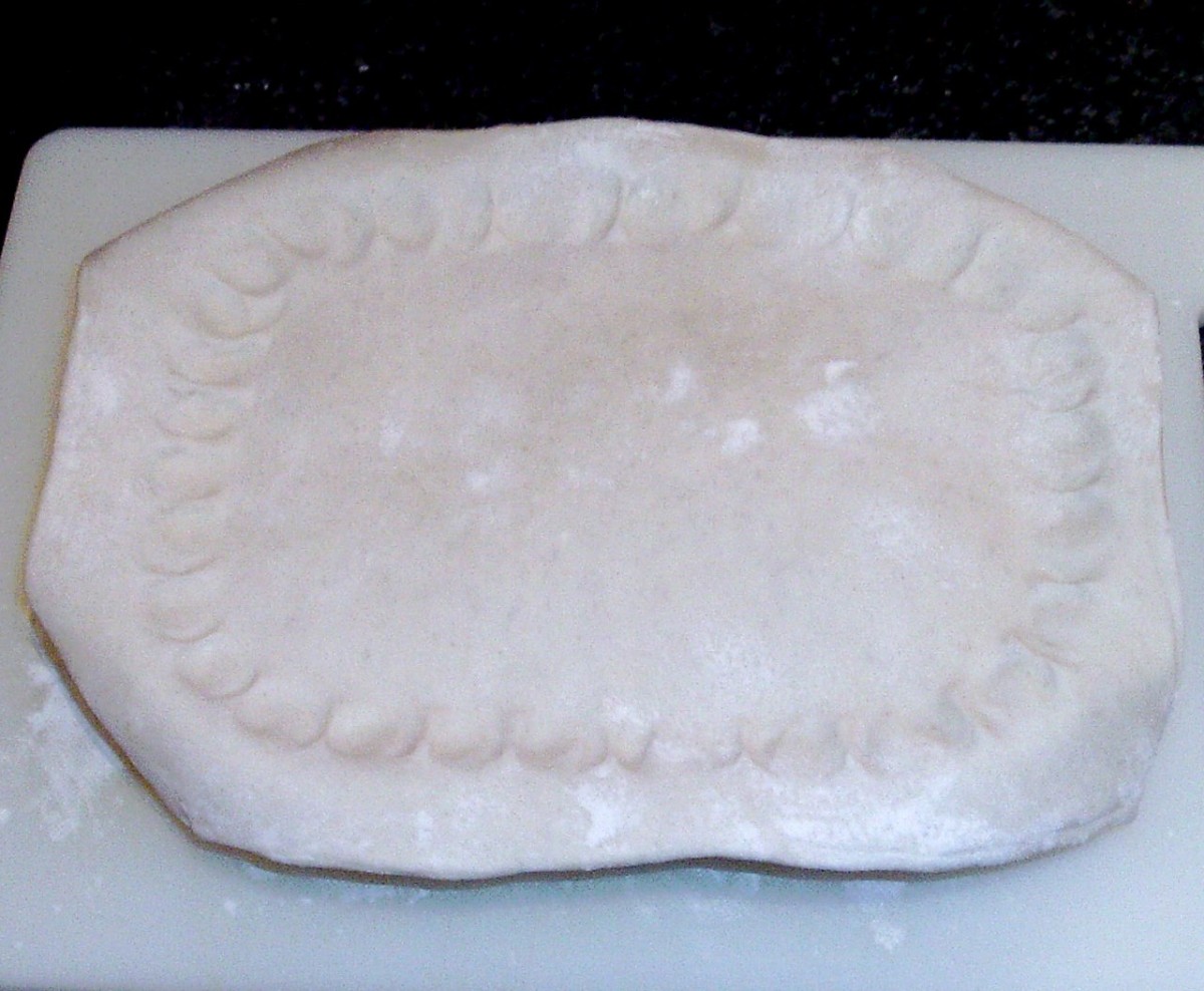 Pastry is fitted on top of pie dish