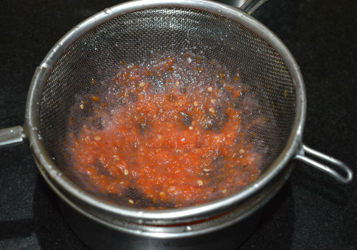 Step two: Make a puree of chopped tomatoes. Strain it. Keep aside.