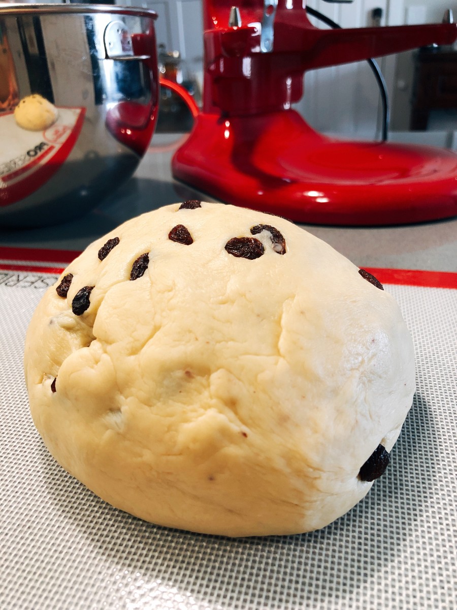Transfer the dough onto a floured surface/baking mat. Shape the dough into a ball. 