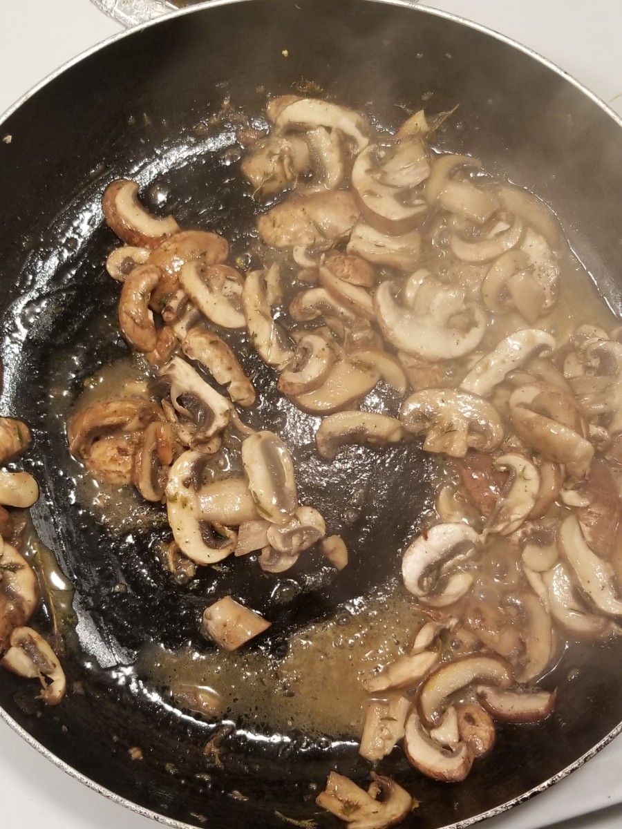 Mushrooms sauteed in pan with butter, thyme, and lemon juice