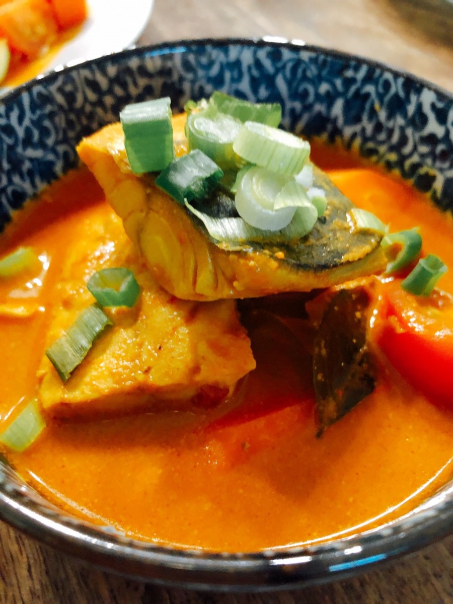 The main ingredients in this dish are fish, coconut milk, and spices. The color of this dish is beautiful, and the taste is delicious. It's best served with steamed white rice or roti. 