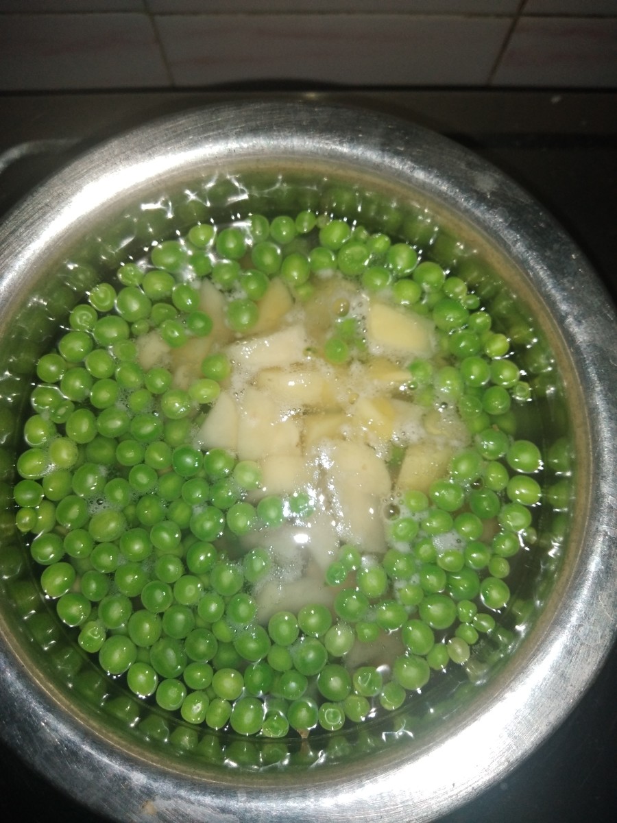 Cube potato. Boil potato and peas with little water and salt.