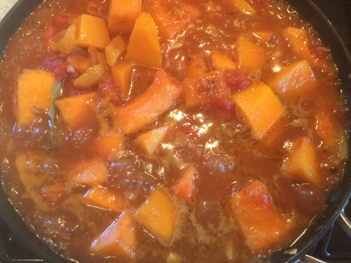 Butternut squash tagine simmering in the pan